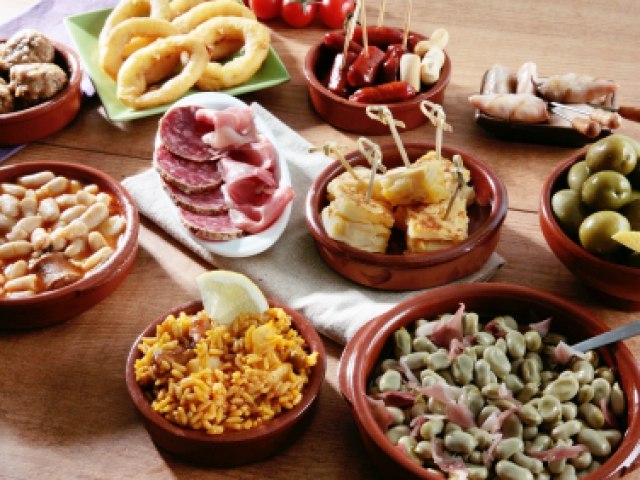 Traditional Spanish Tapas served in clay bowls and plates